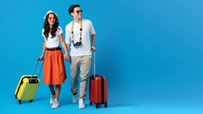 Young couple going for holidays with colorful suitcases